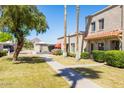 Attractive townhome exterior with manicured lawn and a peek of a mountain in the background at 8107 E Vista Dr, Scottsdale, AZ 85250