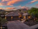 Stunning exterior view of home featuring a tile roof, desert landscaping and attached three car garage at 9628 E Inglewood Cir, Mesa, AZ 85207