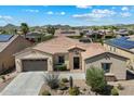 Charming single-story home features a low maintenance desert landscape and a tile roof at 12962 W Lone Tree Trl, Peoria, AZ 85383