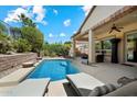 Backyard pool with lounge chairs and covered patio at 12962 W Lone Tree Trl, Peoria, AZ 85383