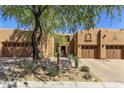 Beautiful exterior featuring tan stucco, desert landscaping and private garage at 13450 E Via Linda -- # 2041, Scottsdale, AZ 85259