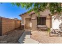 Inviting home exterior with a cozy bench and secure screen door entrance at 15814 W Adams St, Goodyear, AZ 85338