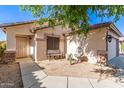 Charming home facade with a quaint seating area and convenient walkway to front door at 15814 W Adams St, Goodyear, AZ 85338
