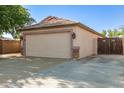 Spacious two-car garage with stone accents and a private side gate at 15814 W Adams St, Goodyear, AZ 85338
