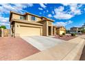 Inviting stucco home with a two-car garage, wide driveway, and colorful drought tolerant landscaping at 16333 N 181St Ave, Surprise, AZ 85388