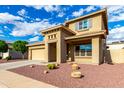 Beautiful stucco home with a two-car garage, drought tolerant landscaping, and a well-maintained front yard at 16333 N 181St Ave, Surprise, AZ 85388