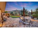 Expansive backyard featuring desert landscaping, a putting green, outdoor seating, and mountain views at 28770 N 69Th Ln, Peoria, AZ 85383