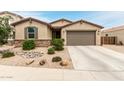 Charming single-story home featuring desert landscaping and a two car garage at 40192 W Brandt Dr, Maricopa, AZ 85138