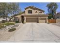Charming two-story home featuring a three-car garage and desert landscaping at 6264 E Omega St, Mesa, AZ 85215