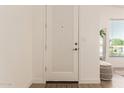 Clean and well lit entryway with white textured door and light wood flooring at 1033 E Mountain Vista Dr, Phoenix, AZ 85048