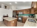 Modern kitchen with stainless steel appliances, granite countertops, and an island at 1033 E Mountain Vista Dr, Phoenix, AZ 85048