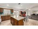 Open kitchen with granite countertops, wood cabinetry, and connection to the dining area at 1033 E Mountain Vista Dr, Phoenix, AZ 85048
