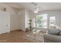 Bright living room with large windows, ceiling fan, and comfortable seating at 1033 E Mountain Vista Dr, Phoenix, AZ 85048