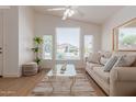 Bright living room with large windows, ceiling fan, and comfortable seating at 1033 E Mountain Vista Dr, Phoenix, AZ 85048