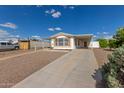 Quaint home with a covered parking, plus a rock and concrete driveway at 1053 S 96Th St, Mesa, AZ 85208