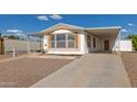 The home is designed with covered parking, plus rock and concrete driveway at 1053 S 96Th St, Mesa, AZ 85208