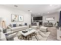 Open-concept living room with a view of the kitchen and dining area and sleek furniture at 10986 W Polk St, Avondale, AZ 85323