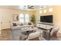 Bright living room featuring arched windows, modern furniture, and stylish decor creating an inviting atmosphere at 11454 W St John Rd, Surprise, AZ 85378