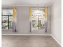 Bright living room with natural light, wood-look floors, and stylish modern window treatments at 11640 N Tatum Blvd # 1031, Phoenix, AZ 85028