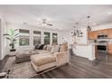 Open concept living room connected to the kitchen with a large sectional at 12335 W Rosewood Ln, Peoria, AZ 85383