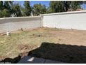Backyard featuring a concrete wall, sparse grass and bare spots at 1414 N Palmsprings Dr, Gilbert, AZ 85234