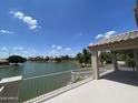 Open-air view from a balcony overlooking the tranquil lake and green trees at 1414 N Palmsprings Dr, Gilbert, AZ 85234