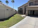 Front yard featuring a well-manicured lawn, a concrete driveway, and a block wall at 1414 N Palmsprings Dr, Gilbert, AZ 85234