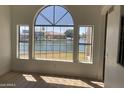 Spacious living area with large windows offering views of the community lake and waterfront homes at 1414 N Palmsprings Dr, Gilbert, AZ 85234