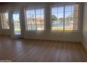 Bright living room with new wood flooring and large windows offering serene lake views at 1414 N Palmsprings Dr, Gilbert, AZ 85234