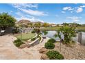 This backyard boasts a putting green, lake view, and stone patio at 15645 S 17Th St, Phoenix, AZ 85048