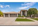 This home features a three-car garage, desert landscaping, and a tile roof at 15645 S 17Th St, Phoenix, AZ 85048