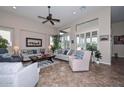 Spacious living room with high ceilings, plantation shutters, and comfortable seating arrangements at 16445 W Berkeley Rd, Goodyear, AZ 85395