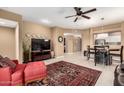 Well-lit living room with a modern TV, decorative accents, and a dining area at 16626 E Westby Dr # 108, Fountain Hills, AZ 85268
