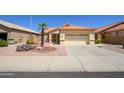 Charming single-story home featuring desert landscaping and a tile roof at 17640 W Babbitt Dr, Surprise, AZ 85374