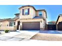 Beautiful home featuring a two-car garage, tile roof, and desert landscaping at 17829 W Sherman St, Goodyear, AZ 85338