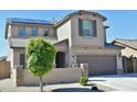 Charming home featuring desert landscaping, a two-car garage, and a tiled roof at 17829 W Sherman St, Goodyear, AZ 85338