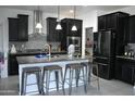 This modern kitchen includes stainless steel appliances and a stylish kitchen island at 17829 W Sherman St, Goodyear, AZ 85338