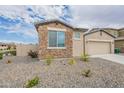 Single-Gathering home with stone facade, desert landscaping, and a two-car garage at 18766 W Montebello Ave, Litchfield Park, AZ 85340