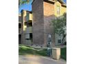 Exterior view of a brick condo building with balconies, green space, and community amenities at 200 E Southern Ave # 133, Tempe, AZ 85282