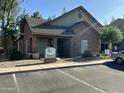 View of the brick leasing office featuring a well maintained and landscaped exterior and ample parking at 200 E Southern Ave # 133, Tempe, AZ 85282