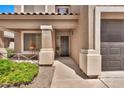 Charming entryway features a cozy front porch and neatly landscaped surroundings at 2418 W White Feather Ln, Phoenix, AZ 85085