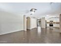 Spacious living room featuring tile flooring, neutral walls, ample lighting, and an open layout at 2418 W White Feather Ln, Phoenix, AZ 85085