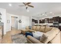 Spacious living area with a comfortable sectional sofa, plush rug, and views into the kitchen at 26065 N 74Th Dr, Peoria, AZ 85383