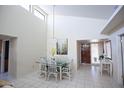 Bright dining room featuring high ceilings and a glass table with seating for six at 2635 N 62Nd St, Mesa, AZ 85215