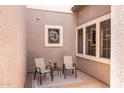 Outdoor seating area with neutral toned chairs and a small table with a plant at 3025 W Sentinel Rock Rd, Phoenix, AZ 85086