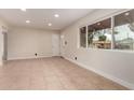 Bright living room featuring neutral paint, tile floors, recessed lights, and large front window at 3916 W Northview Ave, Phoenix, AZ 85051