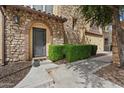 Elegant stone entryway featuring a decorative metal door and manicured boxwood hedges at 4411 N 24Th Way, Phoenix, AZ 85016