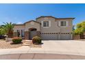 Charming two-story home featuring a three car garage, stone accents, and lovely landscaping at 4490 S Rio Dr, Chandler, AZ 85249