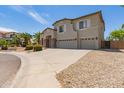 Charming two-story home featuring a three car garage, stone accents, and lovely landscaping at 4490 S Rio Dr, Chandler, AZ 85249