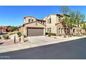 Two-story house featuring a two car garage, neutral stucco, and stone accents at 4777 S Fulton Ranch Blvd # 1024, Chandler, AZ 85248